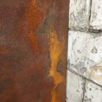Oxidation Venetian plaster against vintage brick tile, London Gymbox