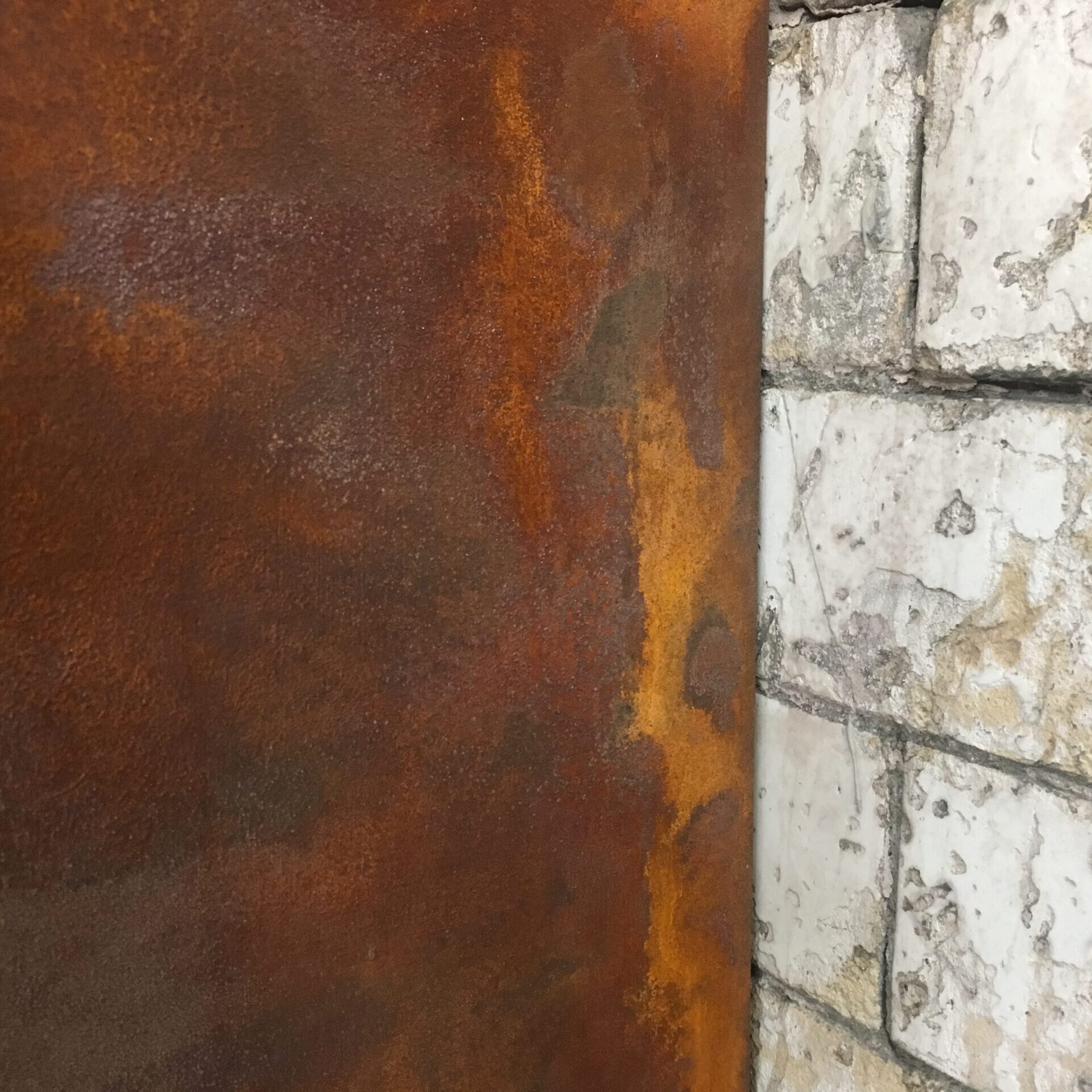 Oxidation Venetian plaster against vintage brick tile, London Gymbox